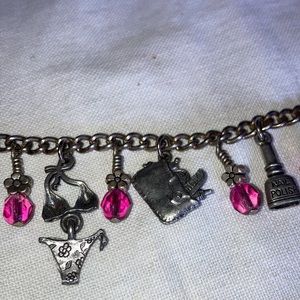 Silvertone charm bracelet with feminine charms and rd pink glassbeads $15